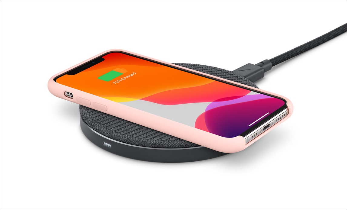 iPhone 14 charging on a Qi wireless charging pad